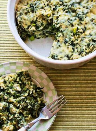 Square image for Spinach Feta Casserole with Brown Rice, one serving shown on plate with whole casserole in back.