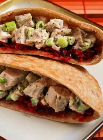 Turkey Pita Sandwiches (with Trina's Cranberry Salsa) shown with two pita halves on plate.