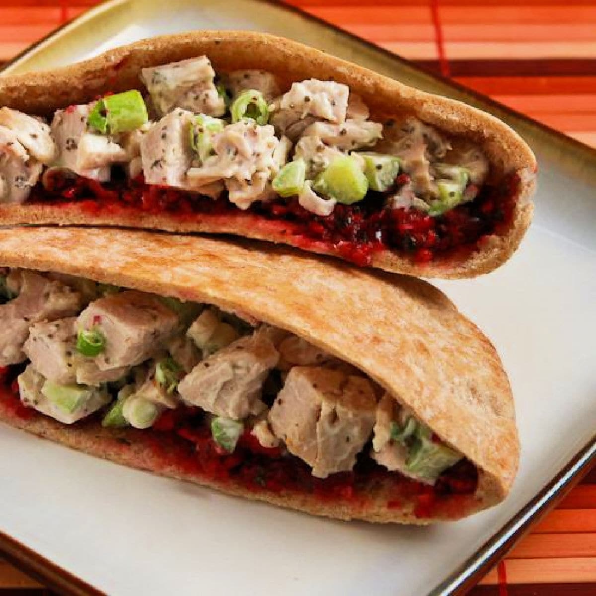 Turkey Pita Sandwiches (with Trina's Cranberry Salsa) shown with two pita halves on plate.