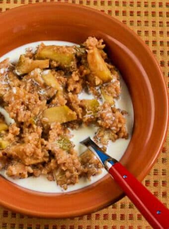 Square image of Apple Pie Oatmeal in serving bowl on napkin with fall colors.