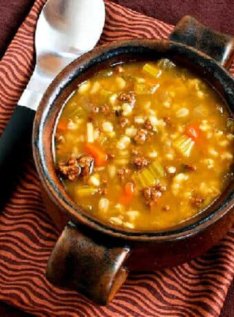 square image of Ground Beef Barley Soup in brown bowl