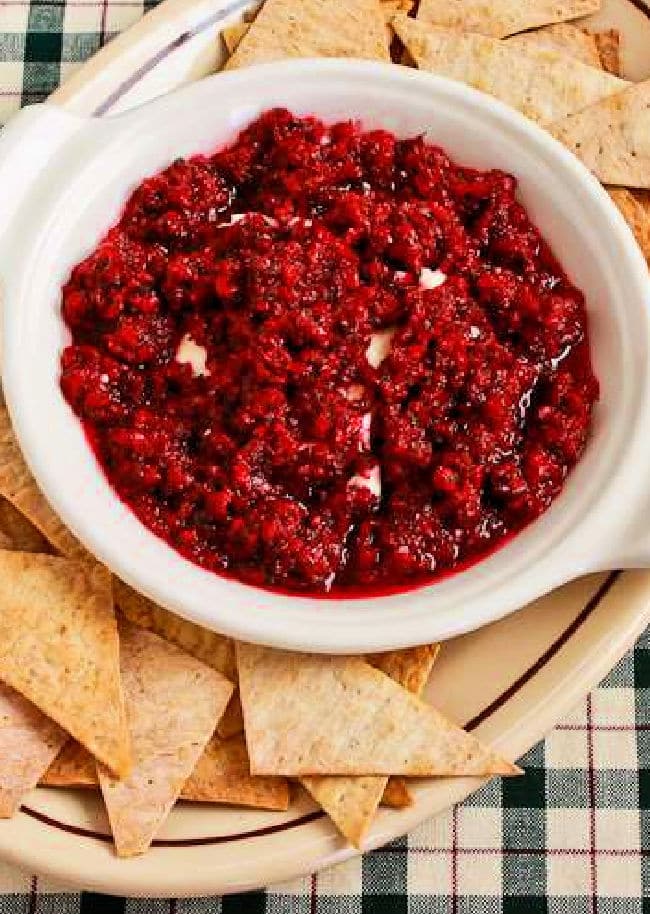 Cranberry Cream Cheese Dip shown on platter with chips.
