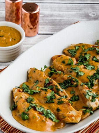 Chicken with Peanut Sauce shown on serving plate with sauce on side