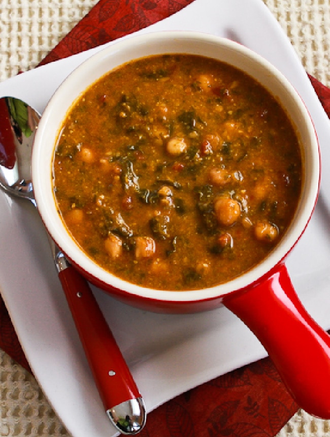 Tomato Chickpea Soup in serving bowl with plate and spoon