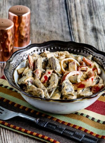 Square image of Vegetarian Mushroom Stew with napkin, fork, and salt-pepper shakers.