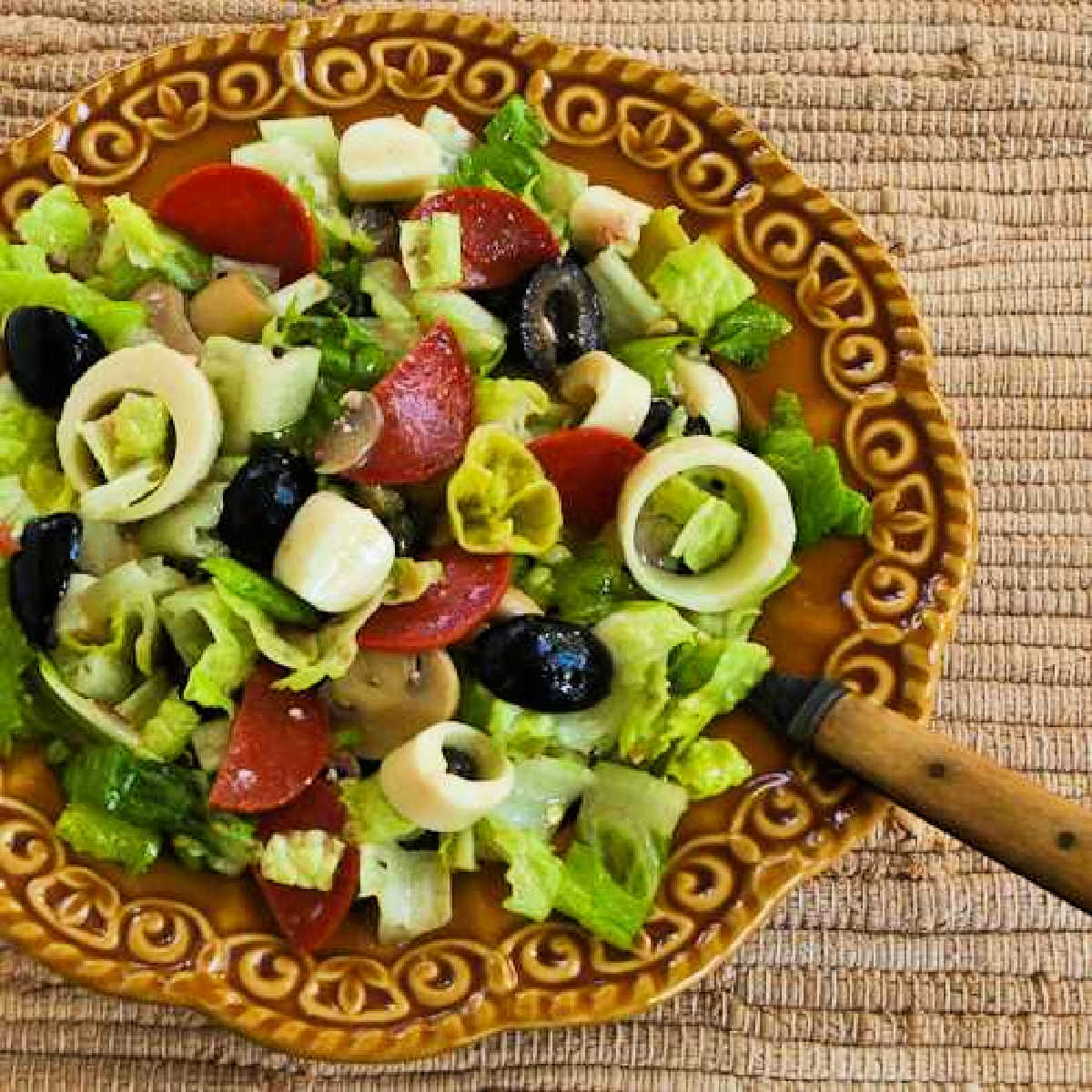 Square image of Antipasto Chopped Salad on plate with fork.