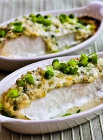 Square image of Baked Halibut with Sour Cream, Parmesan, and Dill Topping shown in two gratin dishes.