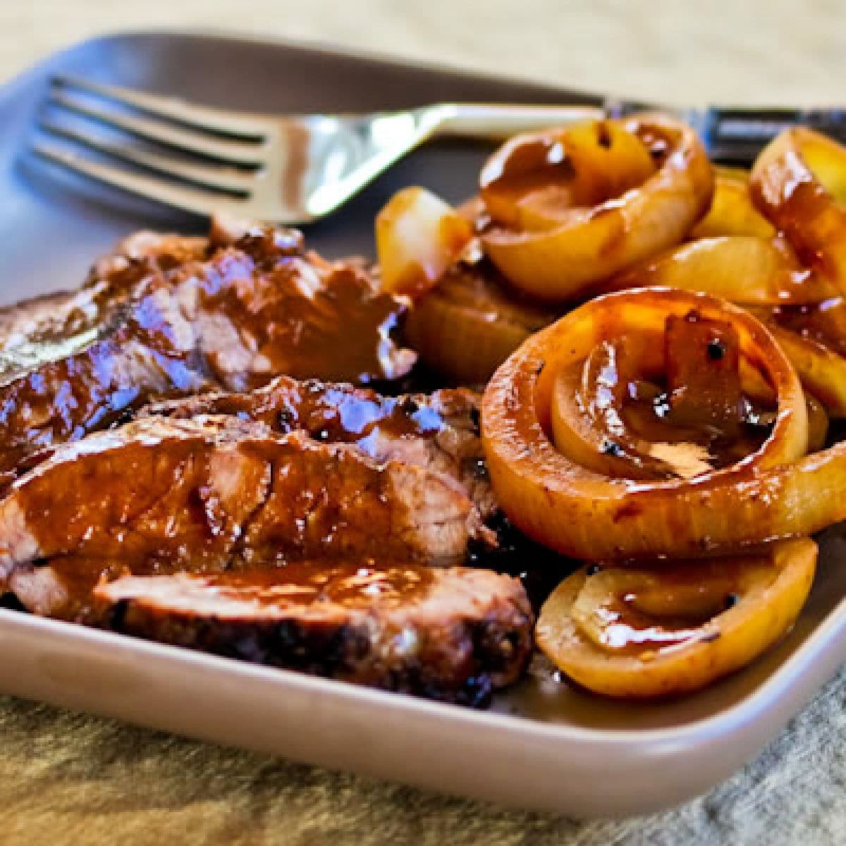 Square image for Slow Cooker Balsamic Pot Roast shown on plate with onions and sauce.