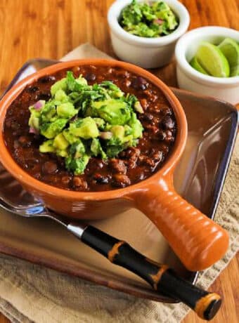 Square image for Black Bean and Beef Chili with avocado salsa, shown in bowl with spoon.