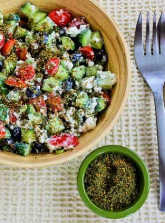 Cottage Cheese Salad with Za'atar shown in serving bowl with Za-atar and forks on the side.