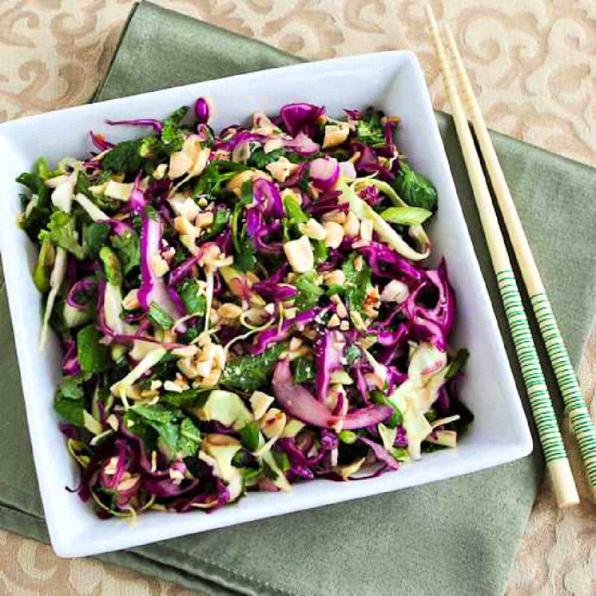 Square image of Thai Cabbage Salad in bowl with chopsticks.