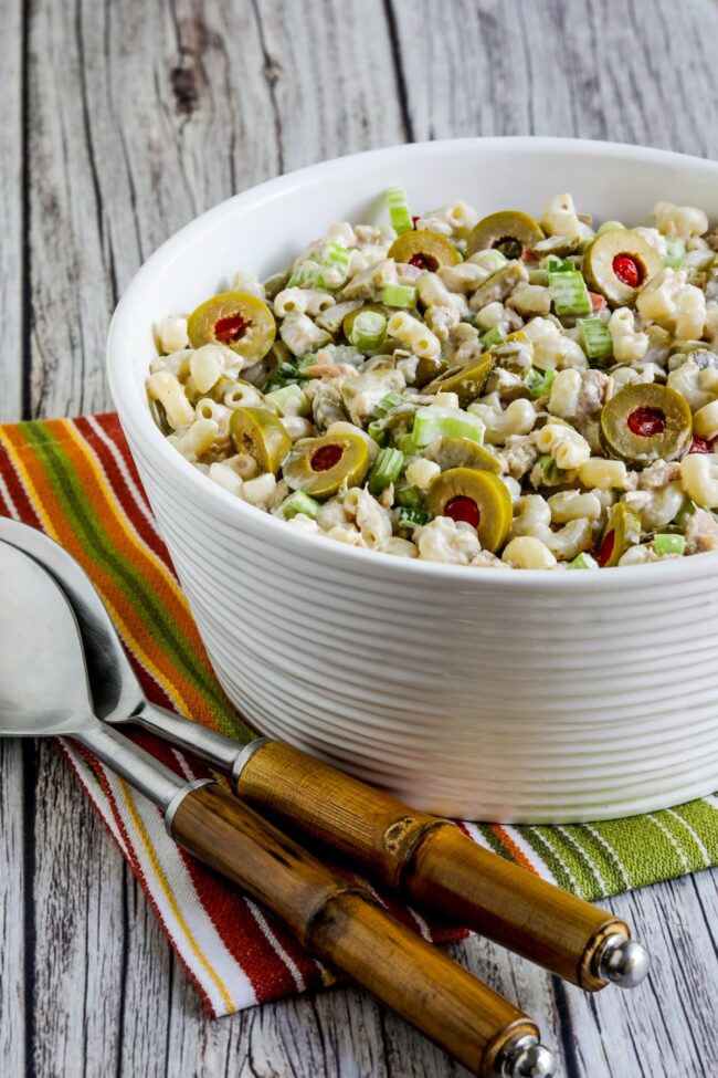 Tuna pasta salad with green olives in a serving bowl