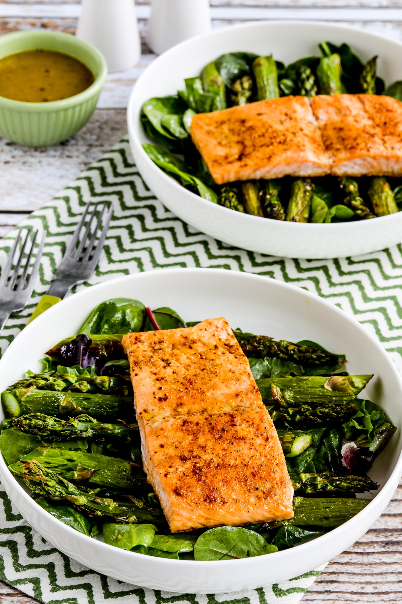 Close-up of salmon and asparagus salad in two large salad bowls