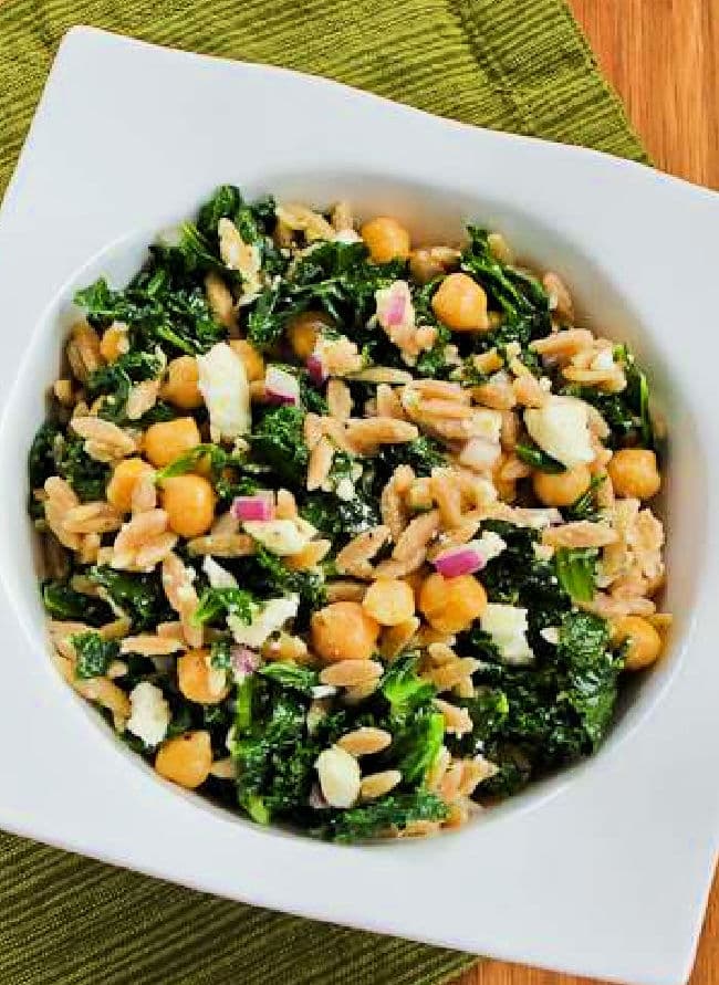 Cropped image of Orzo Salad with Chickpeas and Kale shown in white serving bowl.