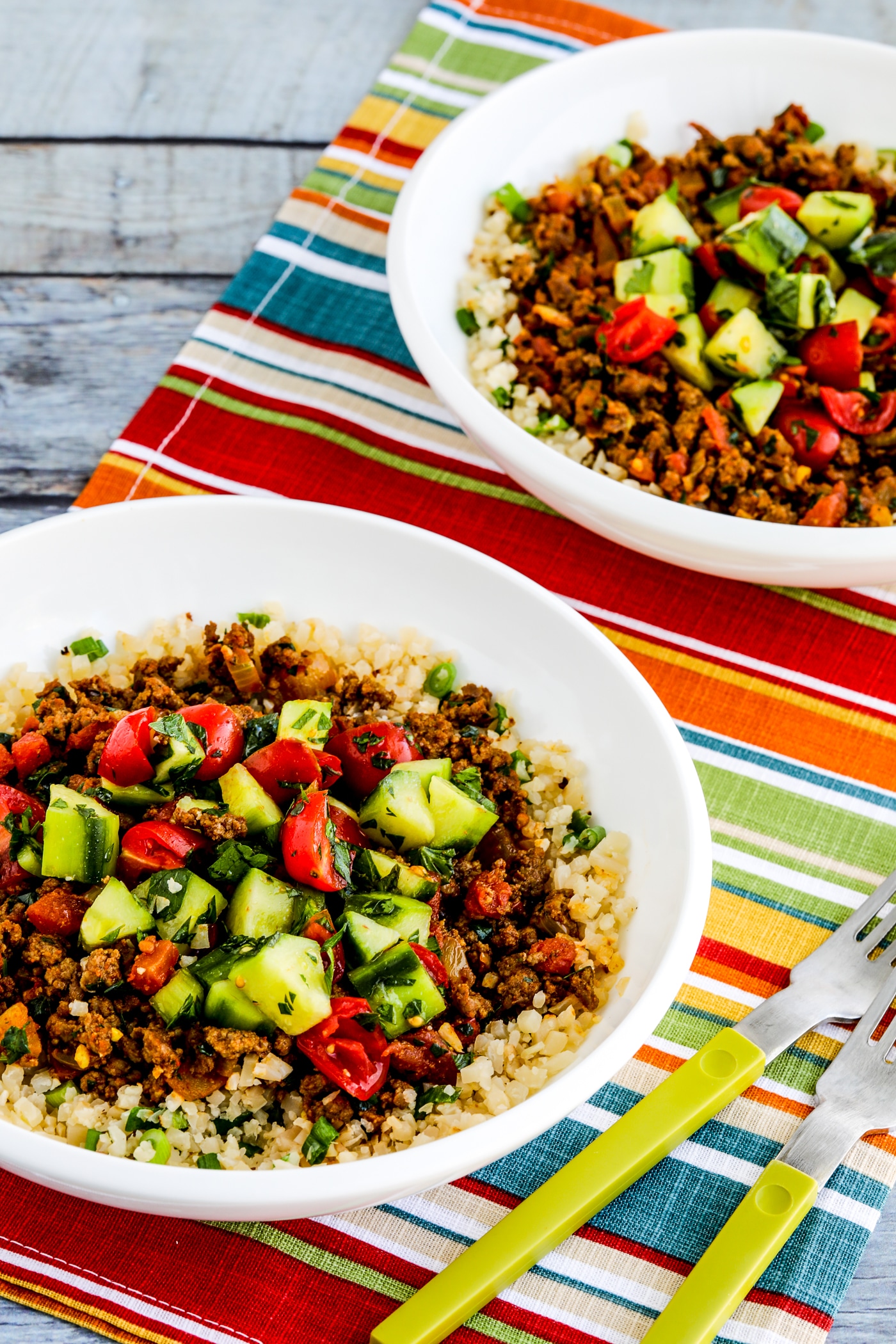 Middle Eastern Ground Beef Bowls two finished bowls on napkin with forks