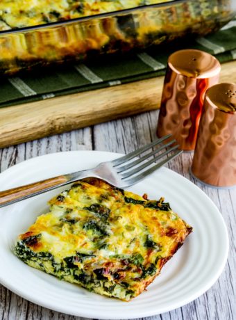 one piece of Kale, Mozzarella, and Egg Bake on plate with casserole dish in background