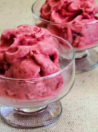 Low-Sugar Strawberry Frozen Yogurt shown in two glass serving dishes.