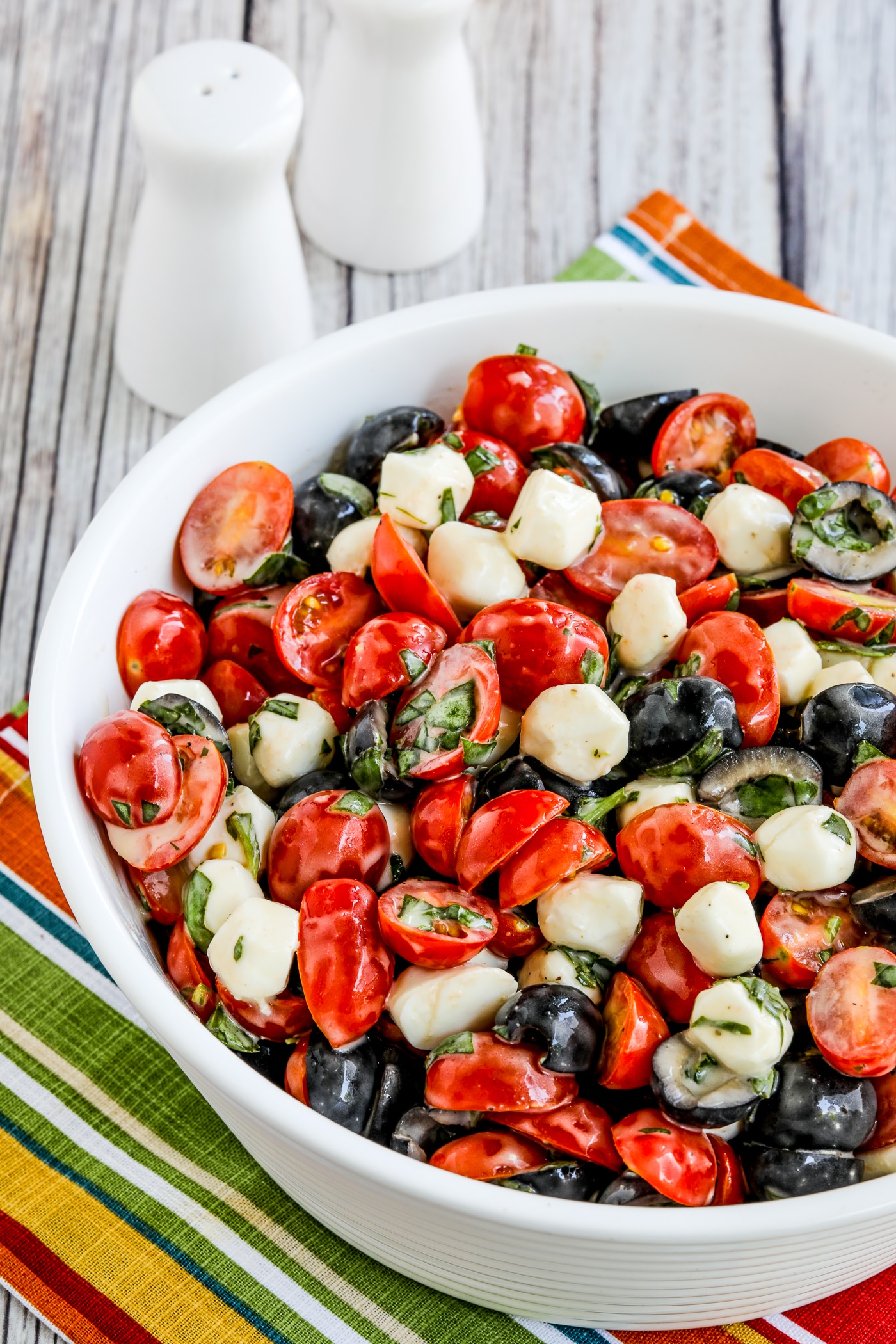 close-up shot of Tomato, Olive, and Fresh Mozzarella Salad finished salad in serving bowl