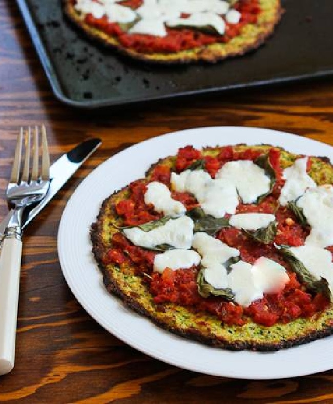 Zucchini Crust Pizza Margherita on serving plate with pan in background