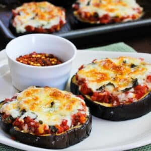 Julia Child's Eggplant Pizza cropped photo with eggplant pizza on serving plate with red pepper flakes