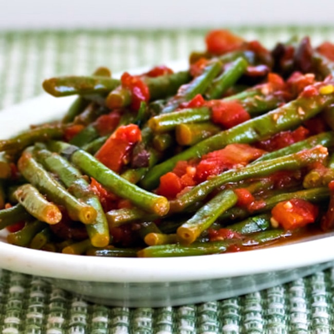 Braised Green Beans with Tomatoes, Olives, and Capers square image of finished green beans on serving plate