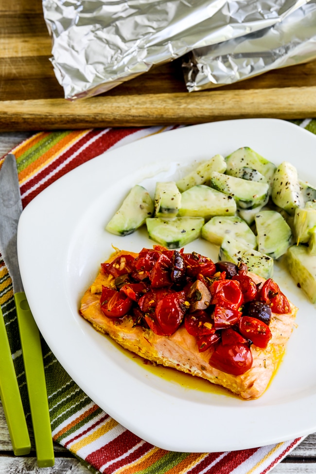 Salmon Foil Packets with Tomatoes and Olives close-up photo of cooked salmon on plate