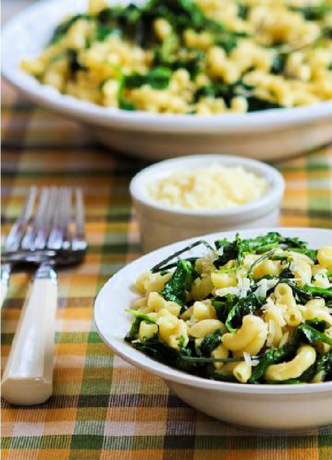 Lemon Parmesan Pasta with Greens shown in two serving dishes with forks, and with larger bowl in back