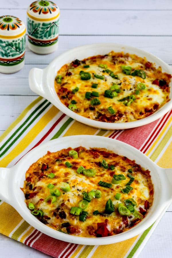 Mexican Baked Eggs finished in two baking dishes with Mexican salt pepper shakers