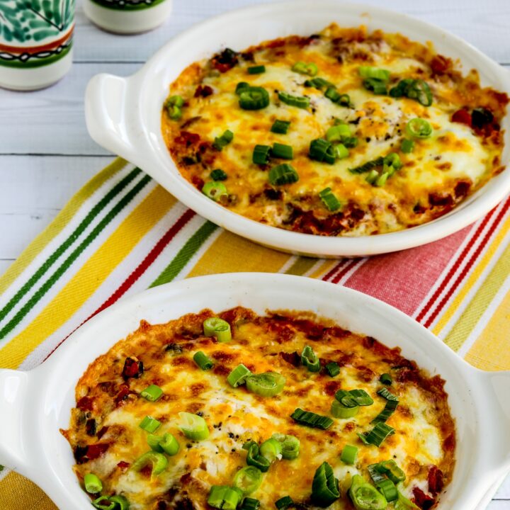 Mexican Baked Eggs finished in two baking dishes with Mexican salt pepper shakers