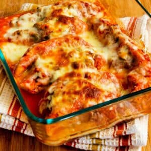 Slow Cooker Salsa Chicken shown in baking dish with melted cheese.