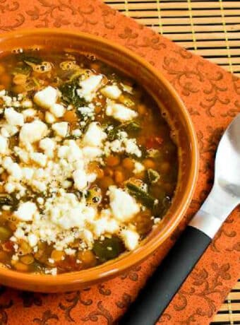 Square image of Slow Cooker Greek Lentil Soup in soup bowl, sprinkled with Feta.