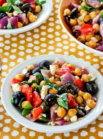 Roasted Vegetable Salad with Chickpeas shown in three bowls with fork.