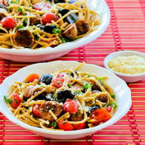 Spaghetti Pasta Salad in two serving bowls on red placemat.