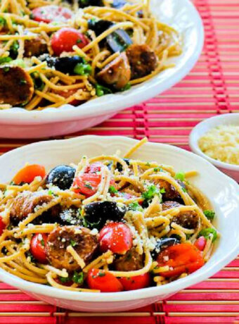 Spaghetti Pasta Salad in two serving bowls on red placemat.