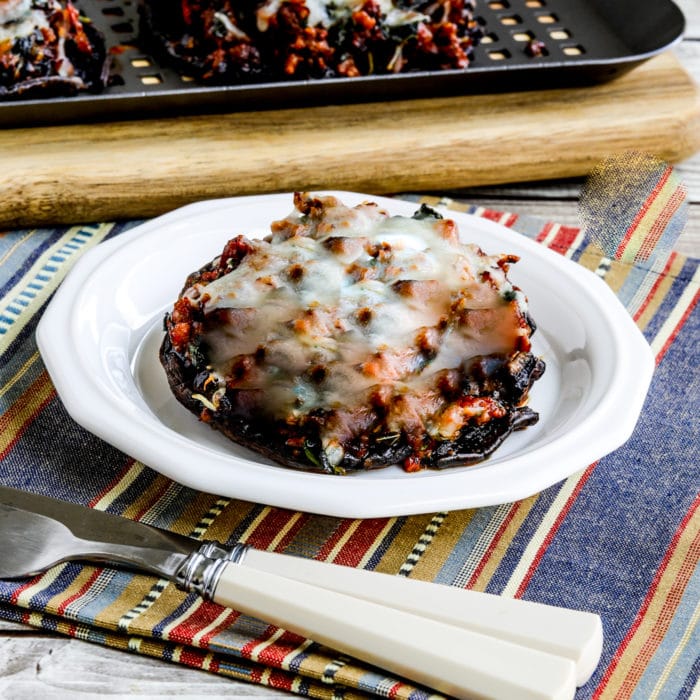 thumbnail square image of Grilled Stuffed Portobello Mushrooms on serving plate with grilling rack in background