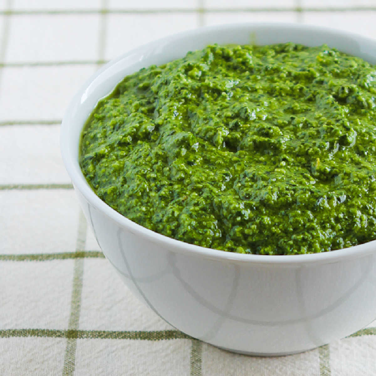 square image of Spinach and Basil Pesto in white bowl