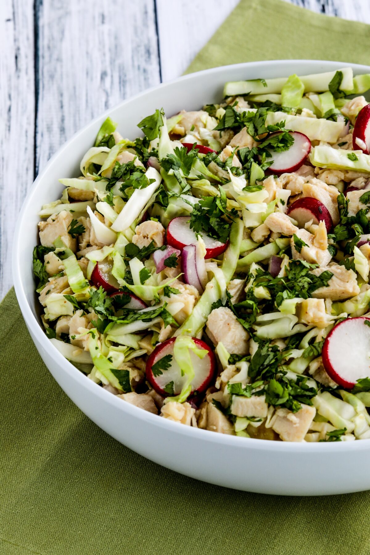 Vietnamese Chicken Salad with Cabbage close-up photo of finished salad in white serving bowl