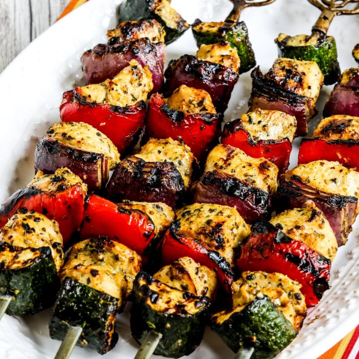 Grilled Chicken Kabobs with Vegetables shown on serving platter on striped napkin.