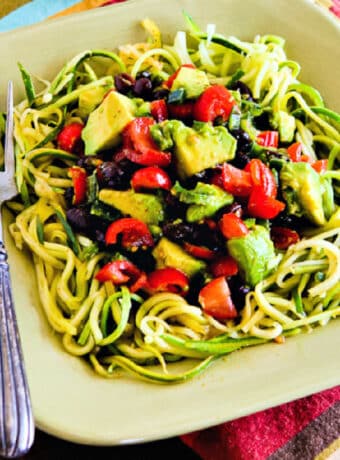 Vegetarian Mexican Bowl with tomato-avocado-poblano topping, shown in serving bowl.