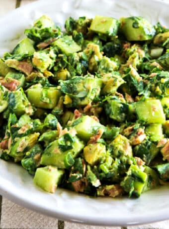 Cucumber Avocado Salad with Tuna shown in serving bowl.