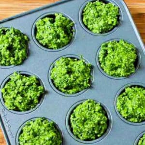 Kale Pesto with Basil shown in muffin tin to be frozen.