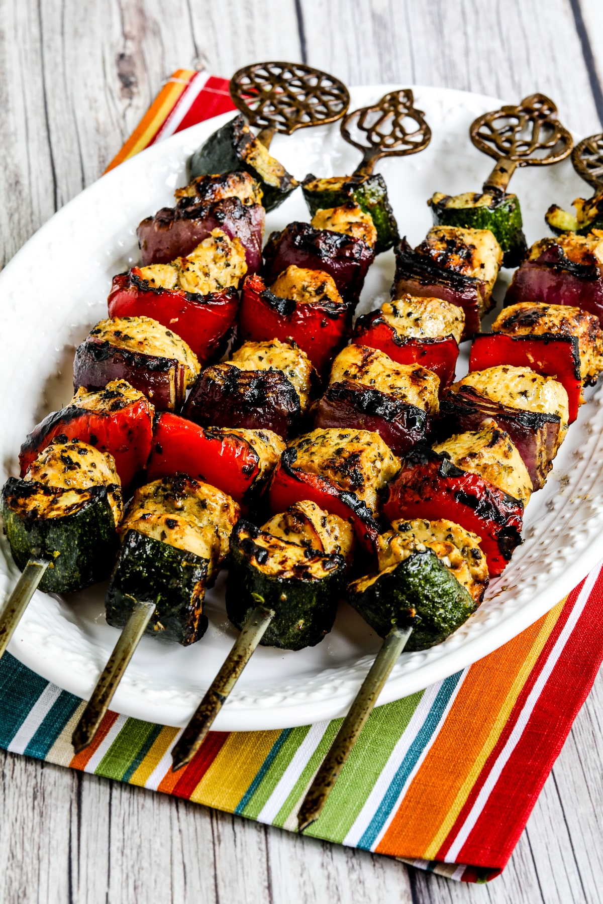 Grilled Chicken Kabobs with Vegetables on platter with striped napkin.