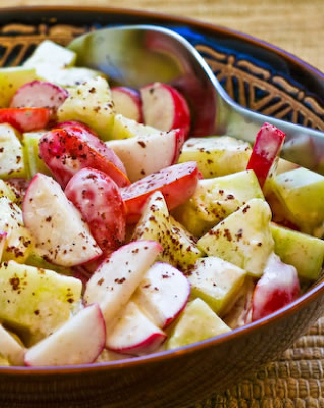 Tomato, Cucumber, and Radish Salad in serving bowl with spoon