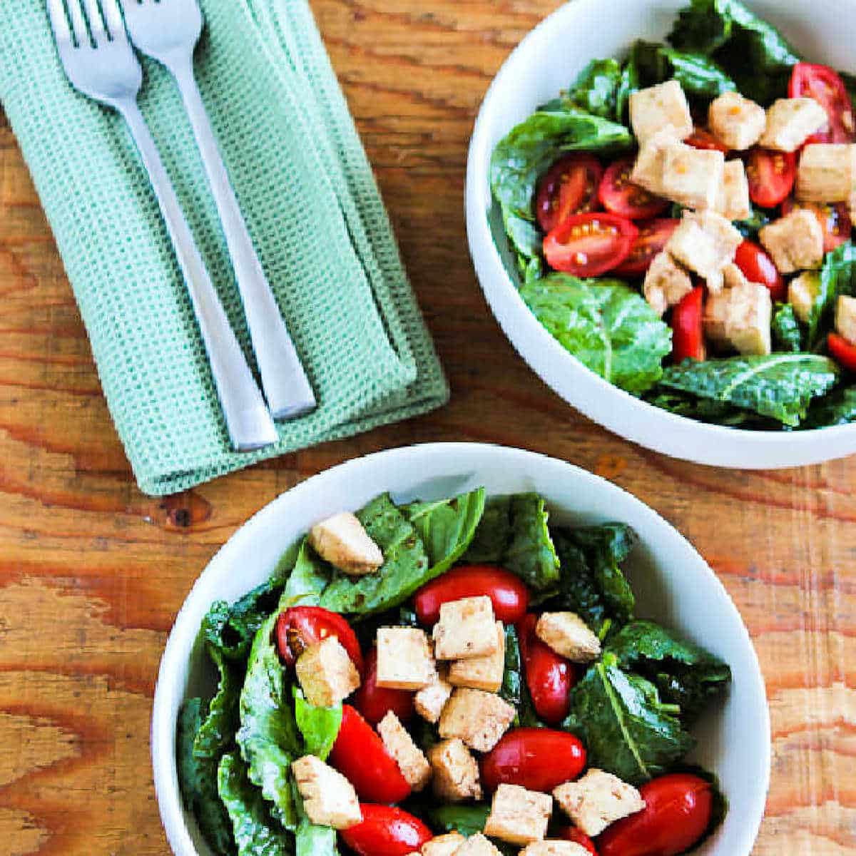 square image of Baby Kale Caprese Salad in serving bowls