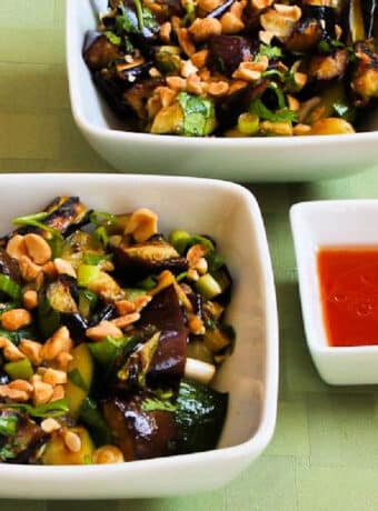 Square image for Thai Eggplant and Zucchini Salad shown in two serving bowls with spicy dressing.