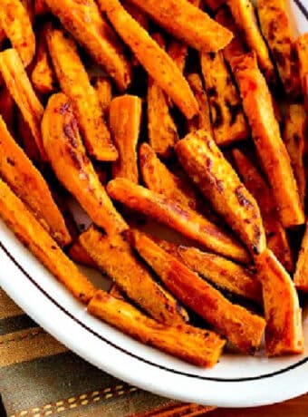Square image for Spicy Baked Sweet Potato Fries shown on serving platter.