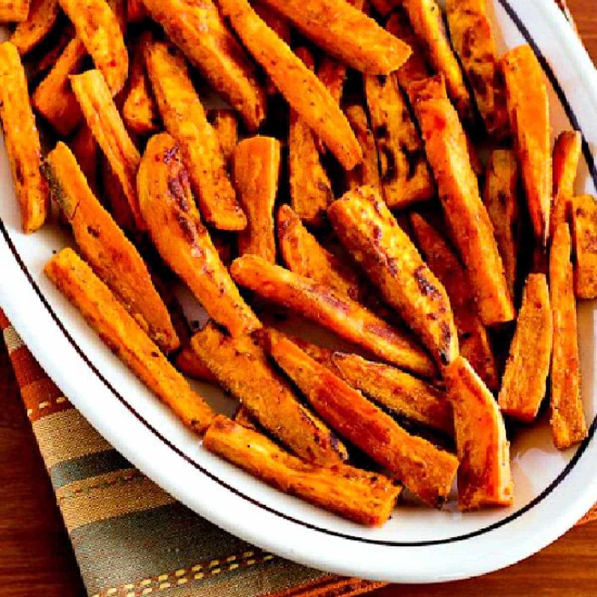 Square image for Spicy Baked Sweet Potato Fries shown on serving platter.