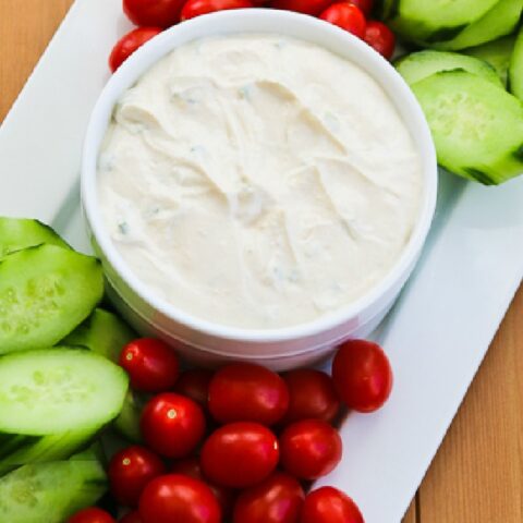 Greek Yogurt Dip close-up photo of greek yogurt with tomatoes and cucumbers