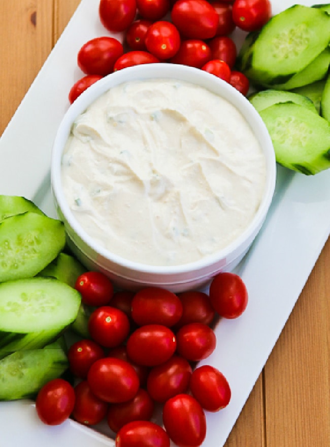 Yogurt Vegetable Dip close-up photo of dip with tomatoes and cucumbers.