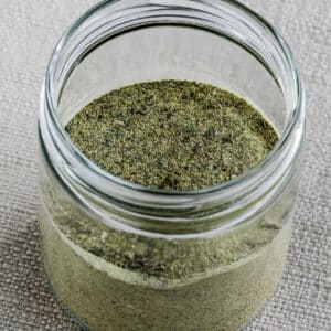 Square image of Kalyn's Herb Blend Recipe shown in glass jar with lid open.